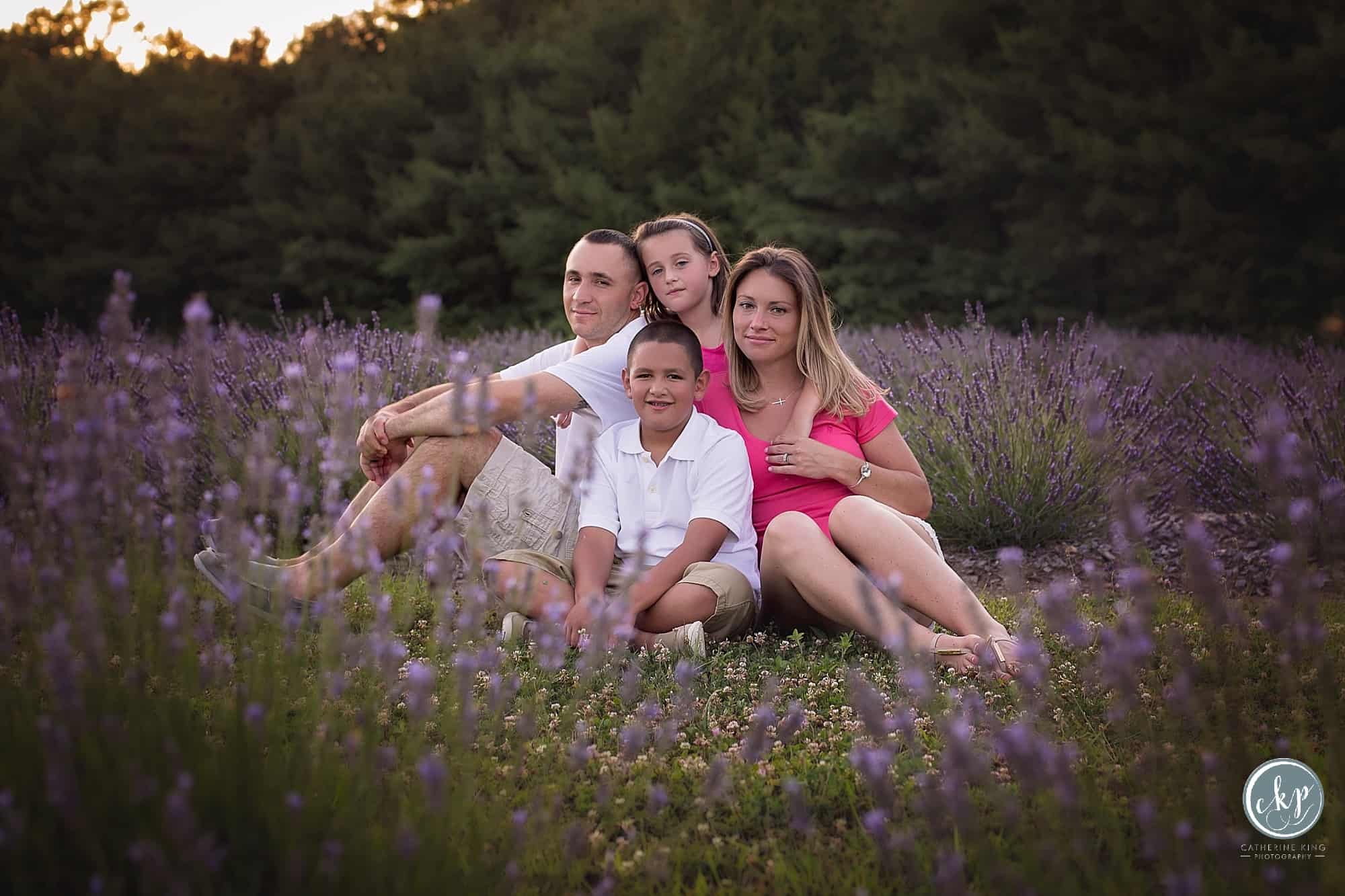a beautiful summer evening photography sessions at lavender pond farm with a family of 4 expecting a baby with ct family photographer catherine king photographer