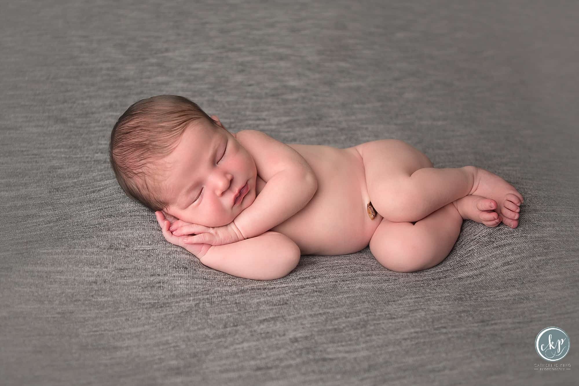 CT Newborn Photographer in Madison CT Photography Studio with a newborn baby girl and a puppy
