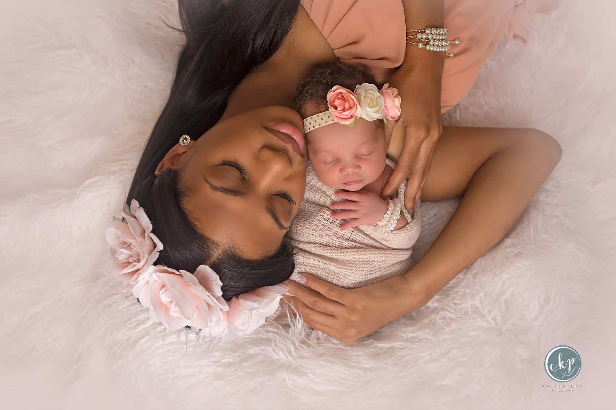 Newborn baby and her mama in a sweet pose
