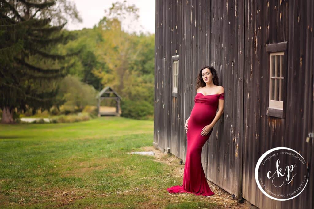 madison ct maternity photography session with a gorgeous red dress by the barn.  Bauer Park Family Session