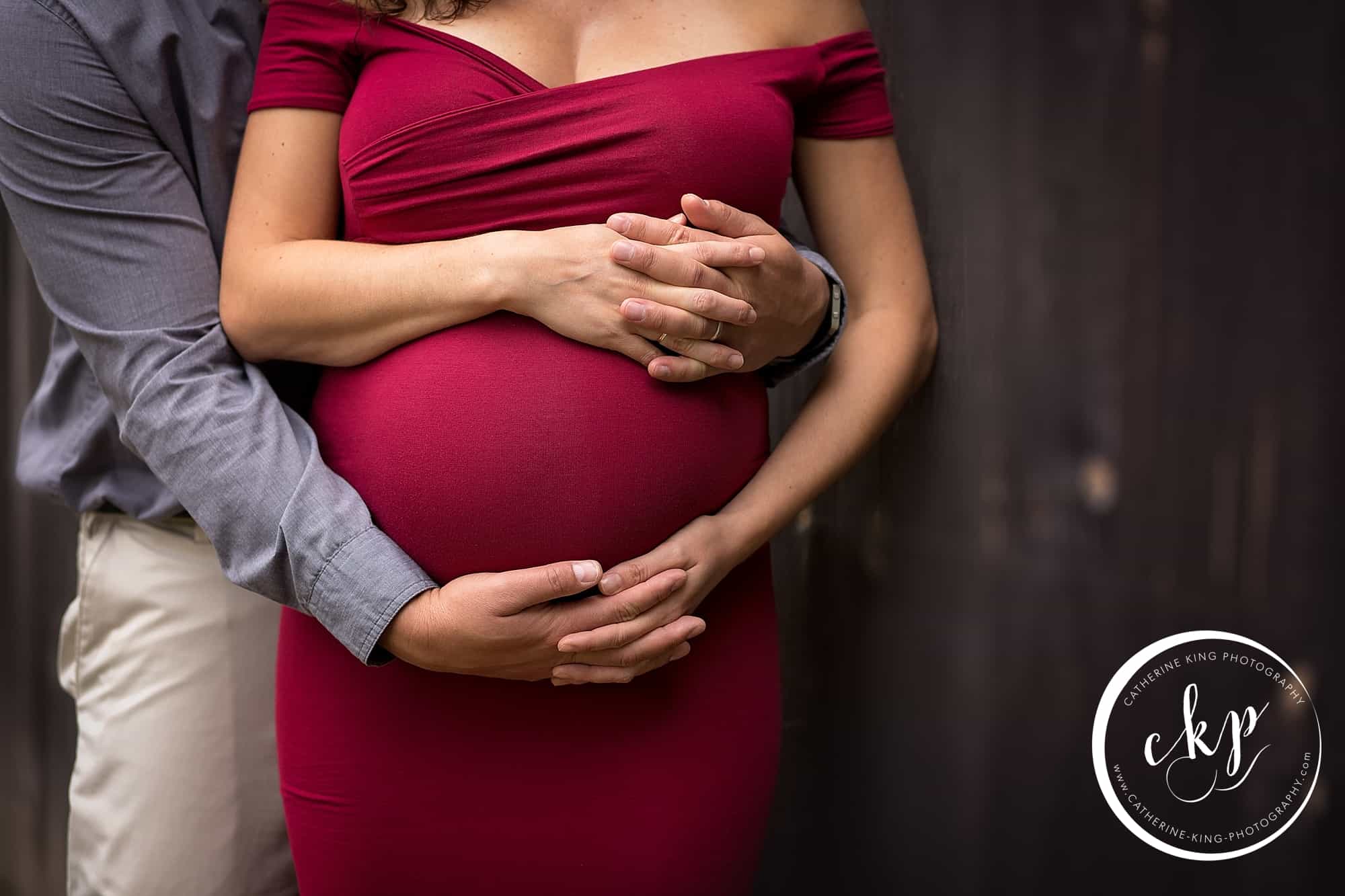 madison ct maternity photography session with a gorgeous red dress by the barn