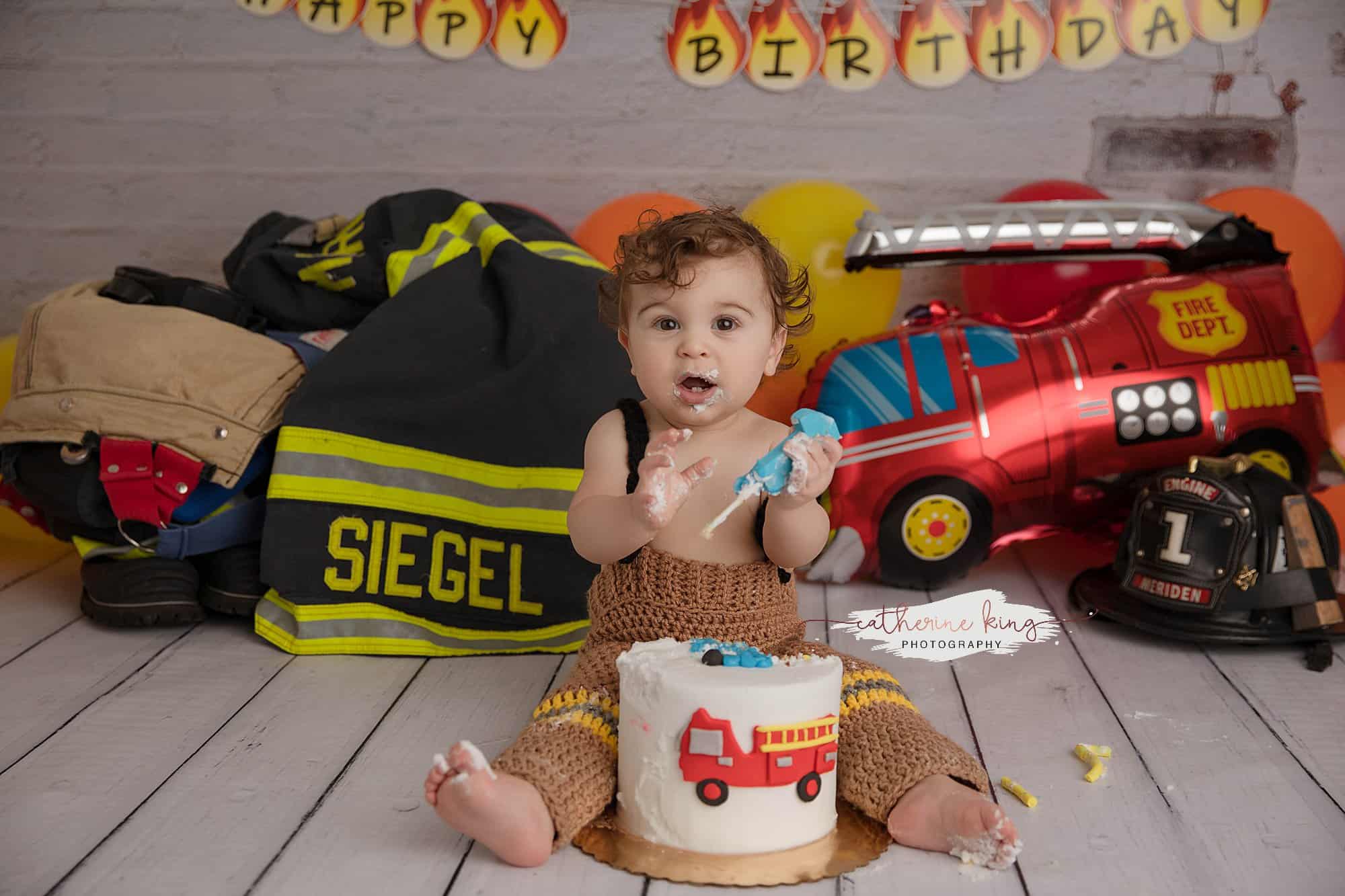 Firefighter themed 1st birthday smashcake with baby boy Colton