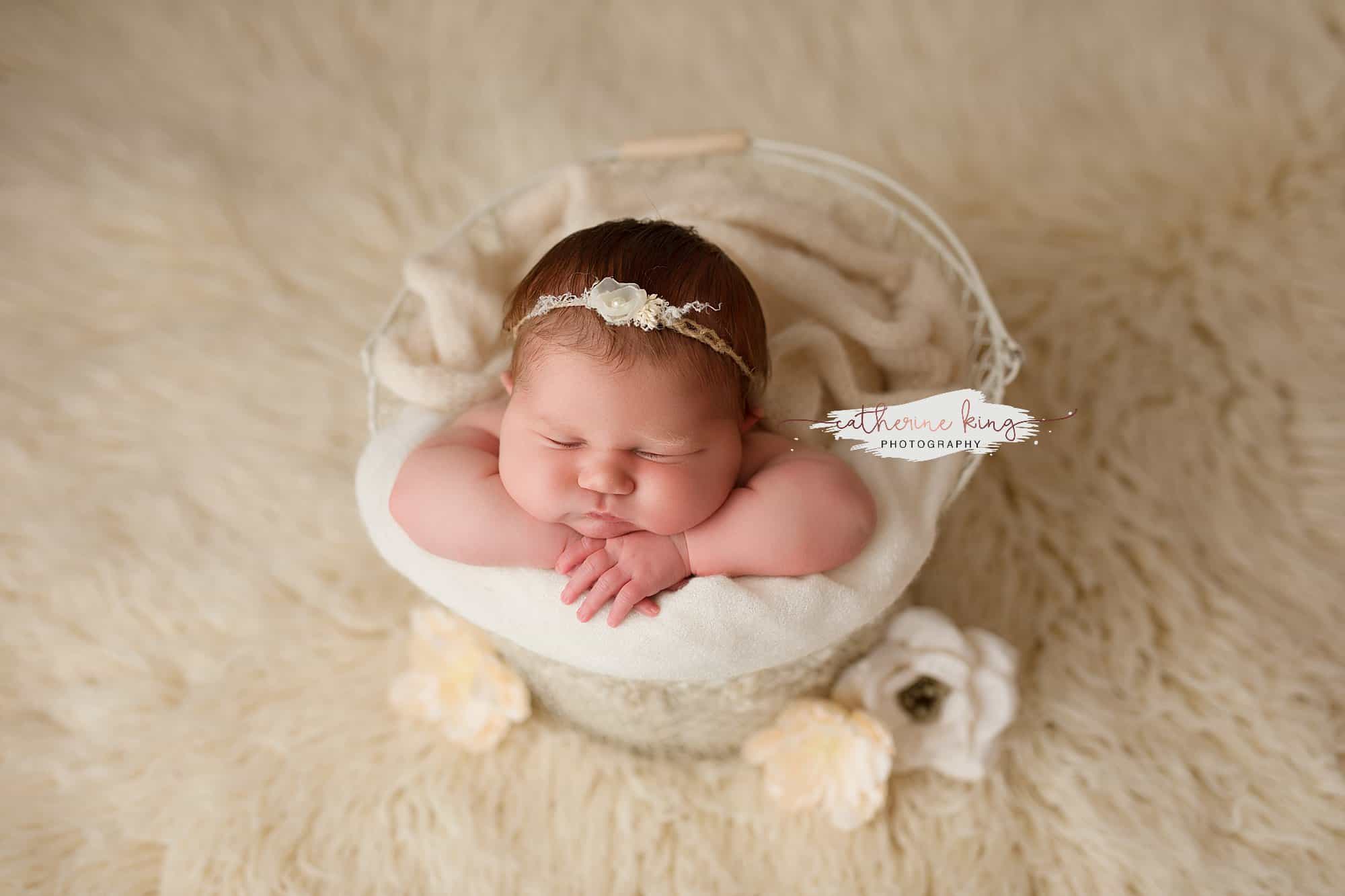 newborn girl in a bucket