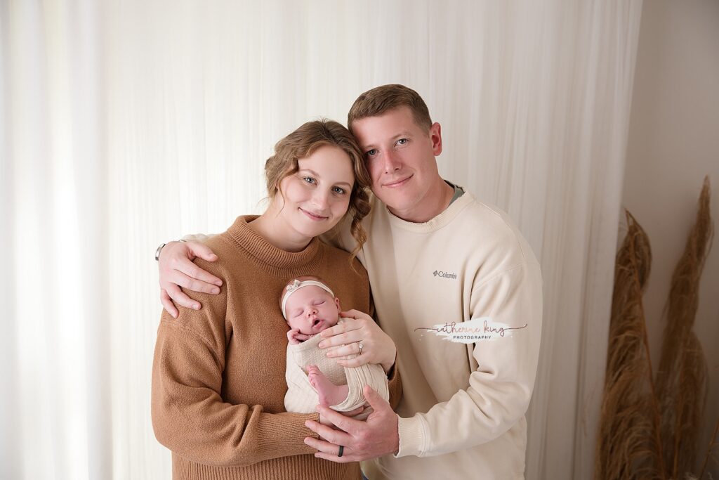 parents with newborn baby studio session